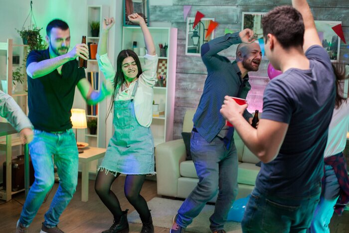 Friends dancing together at a birthday house party