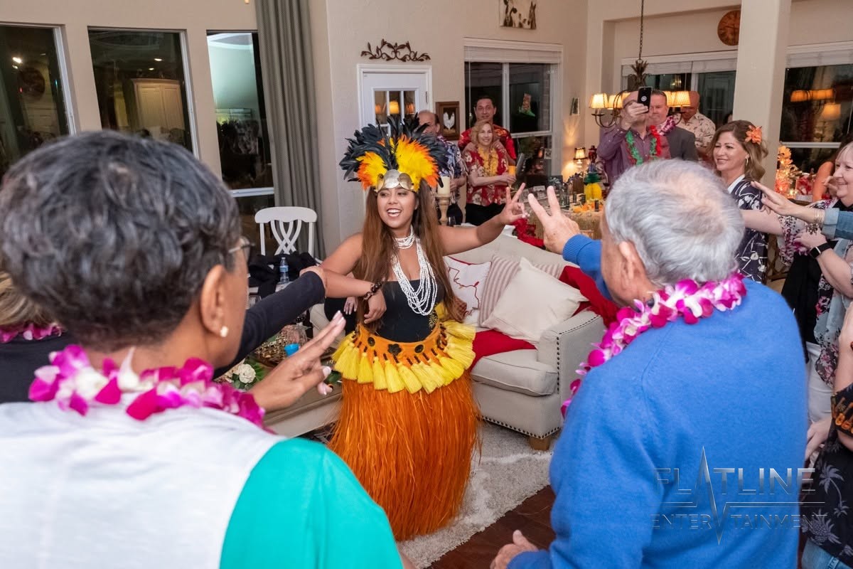 Guests on the dance floor with a hula dancer at a birthday party