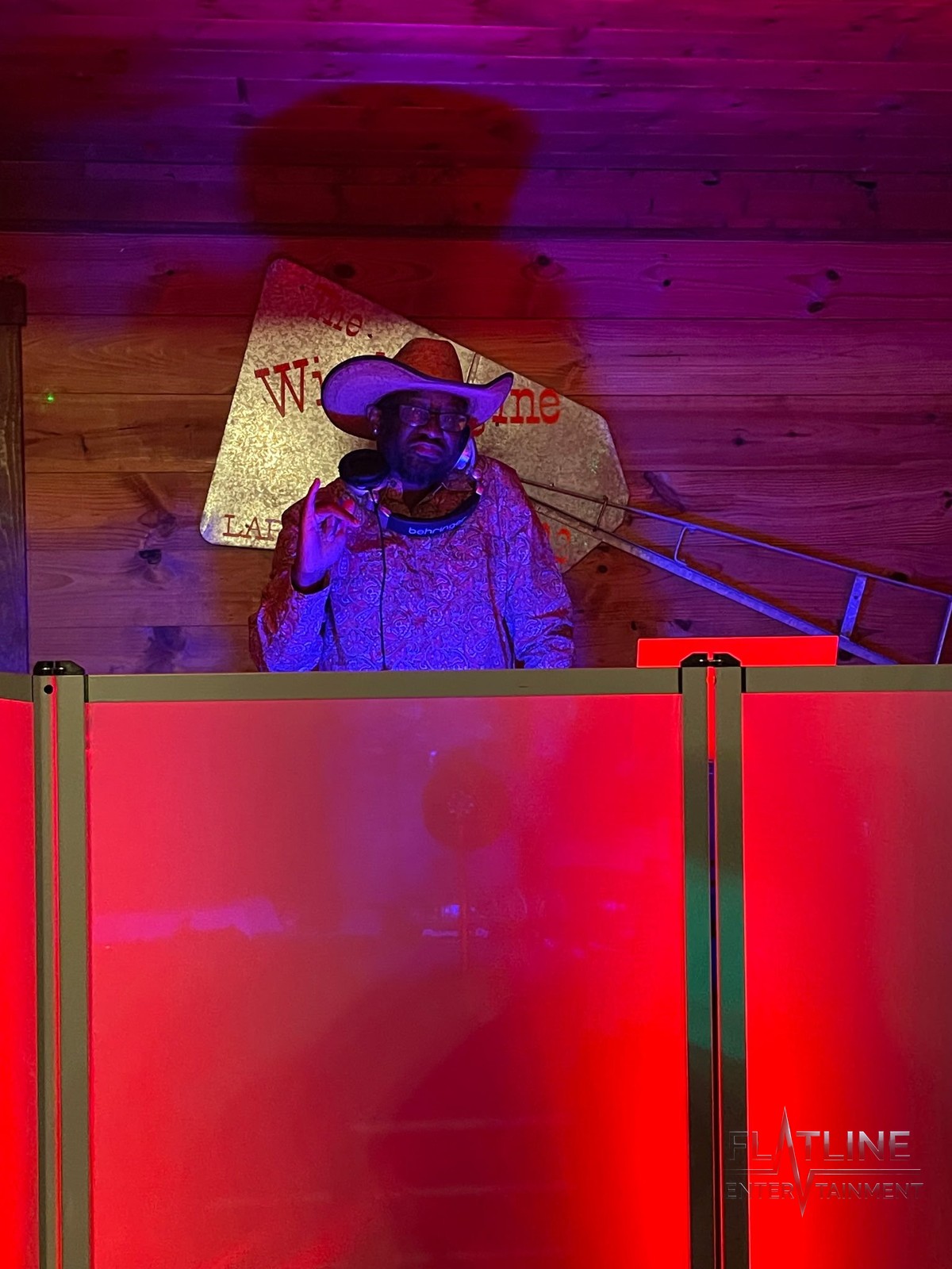 Mark Anthony DJing live at the booth in a cowboy hat